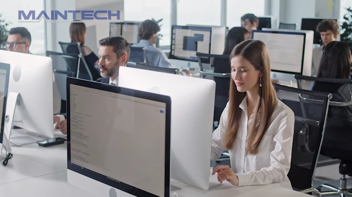 Workers sat in office using computers